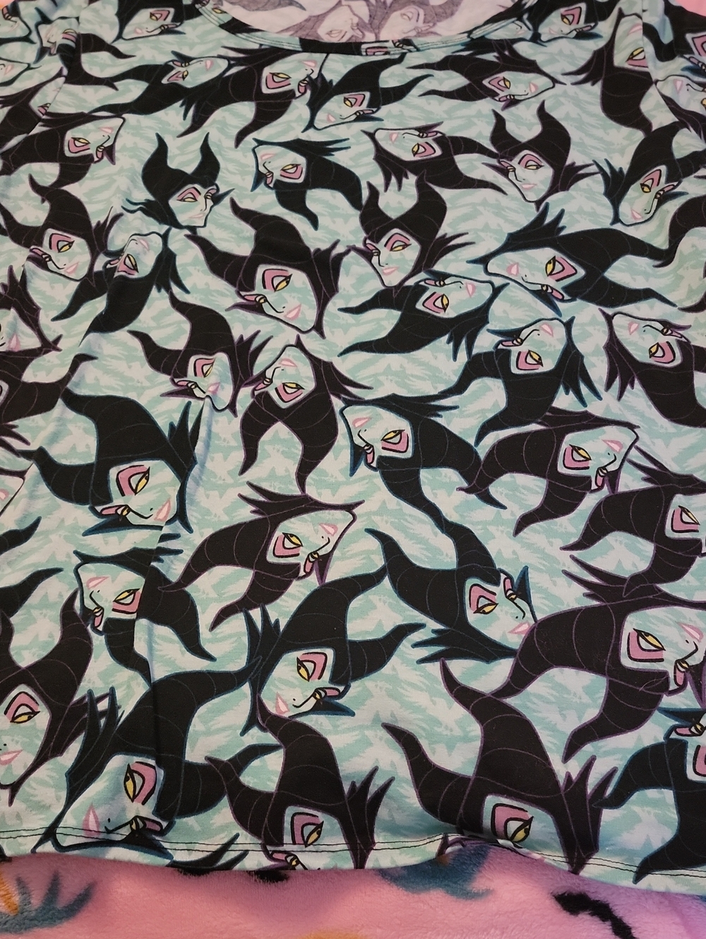 LuLaRoe Disney Maleficent Shirt on pastel mint and black fabric
